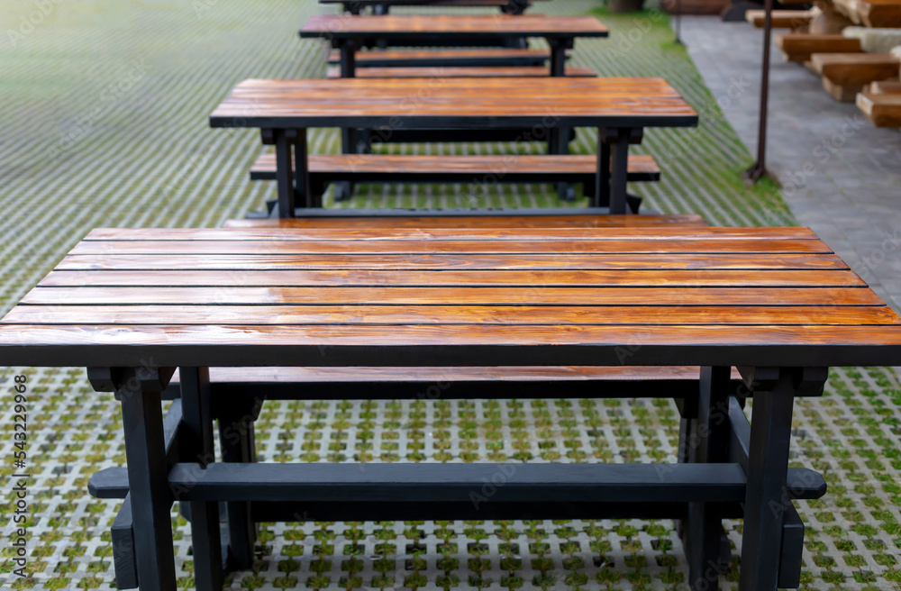 Fototapeta premium Many new tables with benches outside