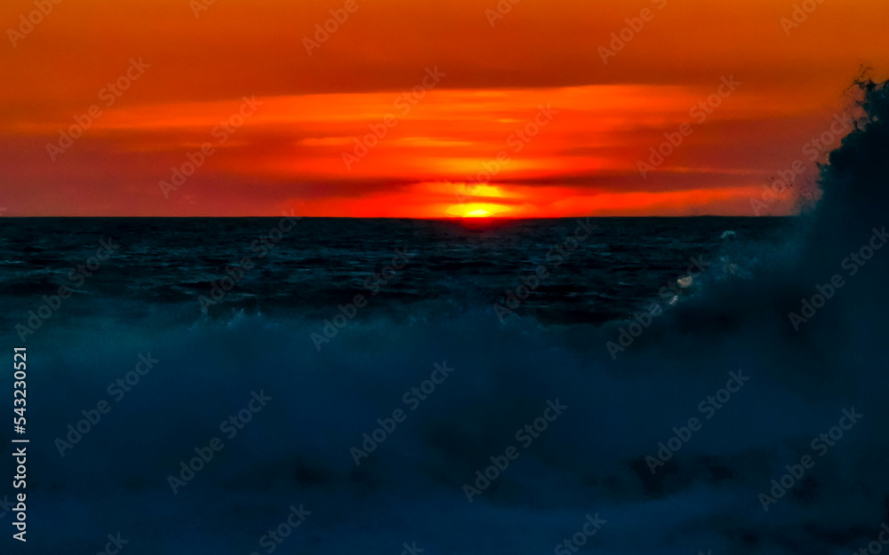 Colorful golden sunset big wave and beach Puerto Escondido Mexico.