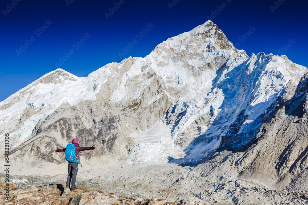 Happy hiker walking in the mountains. Himalayas, Everest Base Camp trek, Nepal Happy hiker walking in the mountains. Himalayas, Everest Base Camp trek, Nepal