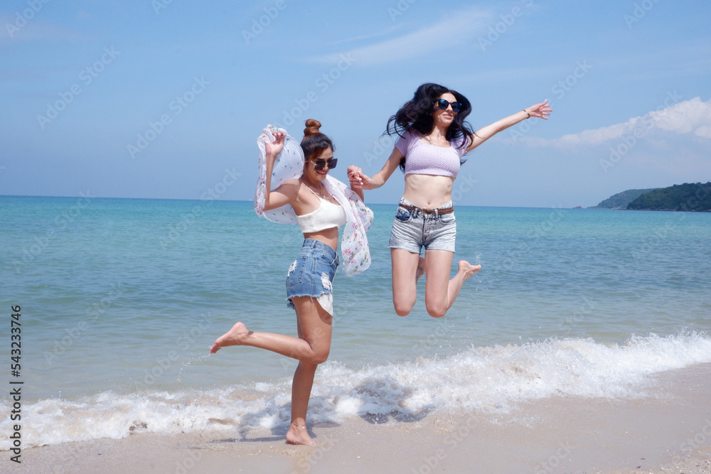 A beautiful woman jumped high on the beach.