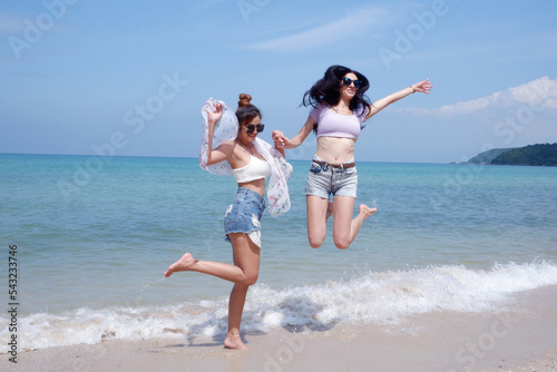 A beautiful woman jumped high on the beach.