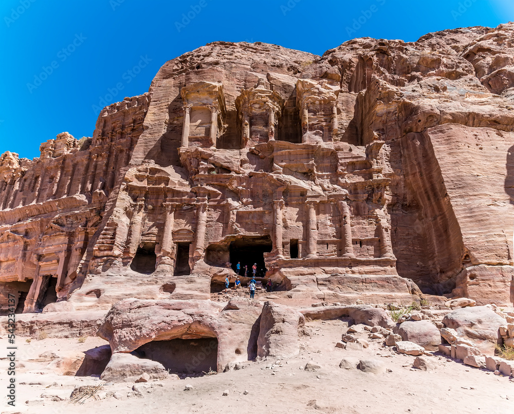 A view towards Royal Tombs carved into the cliff face in the ancient city of Petra, Jordan in summertime