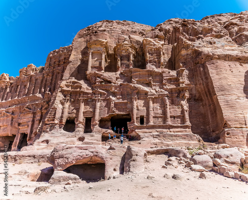 A view towards Royal Tombs carved into the cliff face in the ancient city of Petra, Jordan in summertime