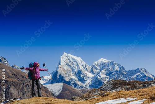Hiking in Himalaya mountains. Woman Traveler with Backpack hiking in the Mountains. Travel sport lifestyle concept