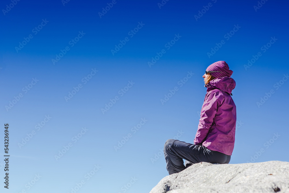 Woman Traveler sitting in the Mountains with beautiful summer Himalayas landscape on the background Woman Traveler sitting in the Mountains with beautiful summer Himalayas landscape on the background
