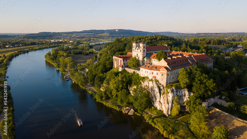 Benedictine Abbey in Tyniec is stunning monastery above the river. Historical church on rock with medieval look and mood. Drone footage of this chapel. Landscape of Poland rural countryside sunset.