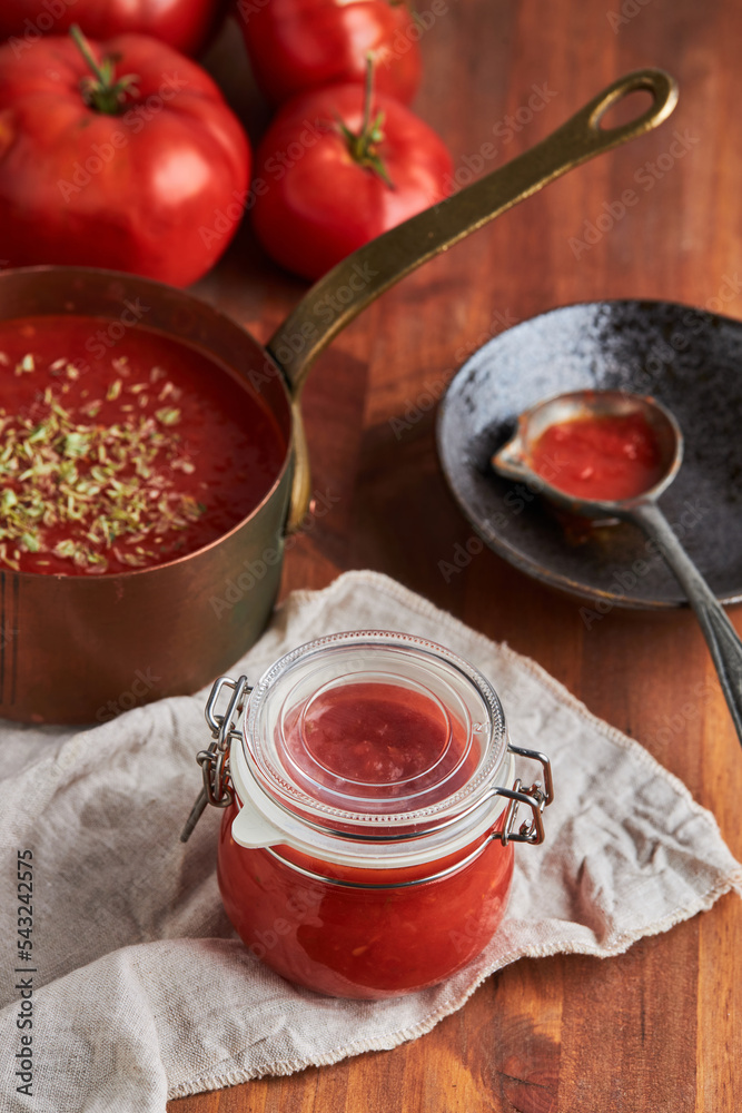 Containers with tomato sauce on table Containers with tomato sauce on table