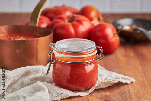 Glass jar with tomato sauce photo