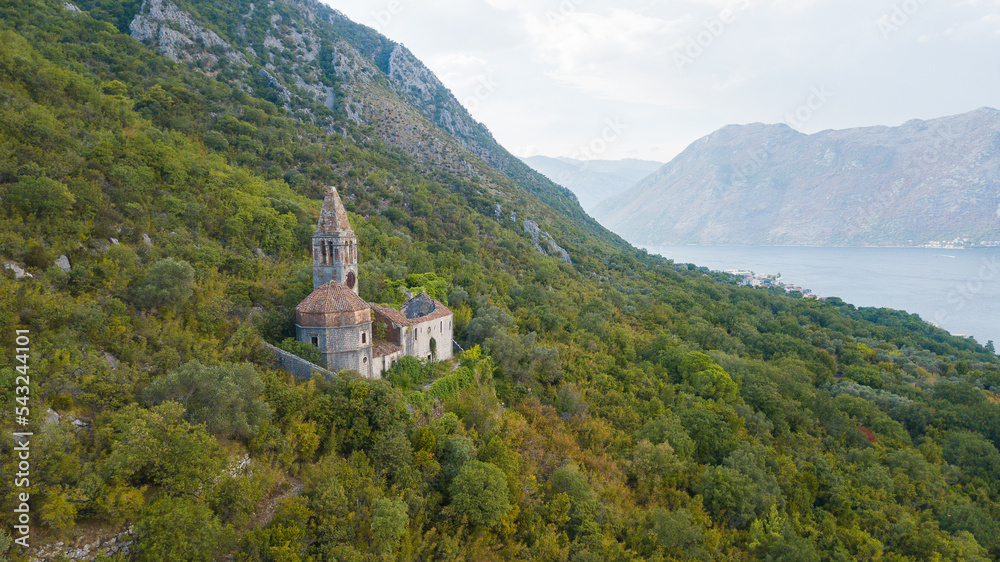 Catholic church ruin in Kotor bay of Montenegro. Chapel and place looks like Caribbean. Little monastery lies in the mountains in Crna gora. Saint place with nice surrounding nature and landscape.