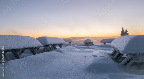 Winter landscape in Czech mountains. Snowy nature during sunrise. Frozen mountains and trees. Lysa hora lies in Beskydy mountains. This is peak is real tourist attraction and high frequent place.