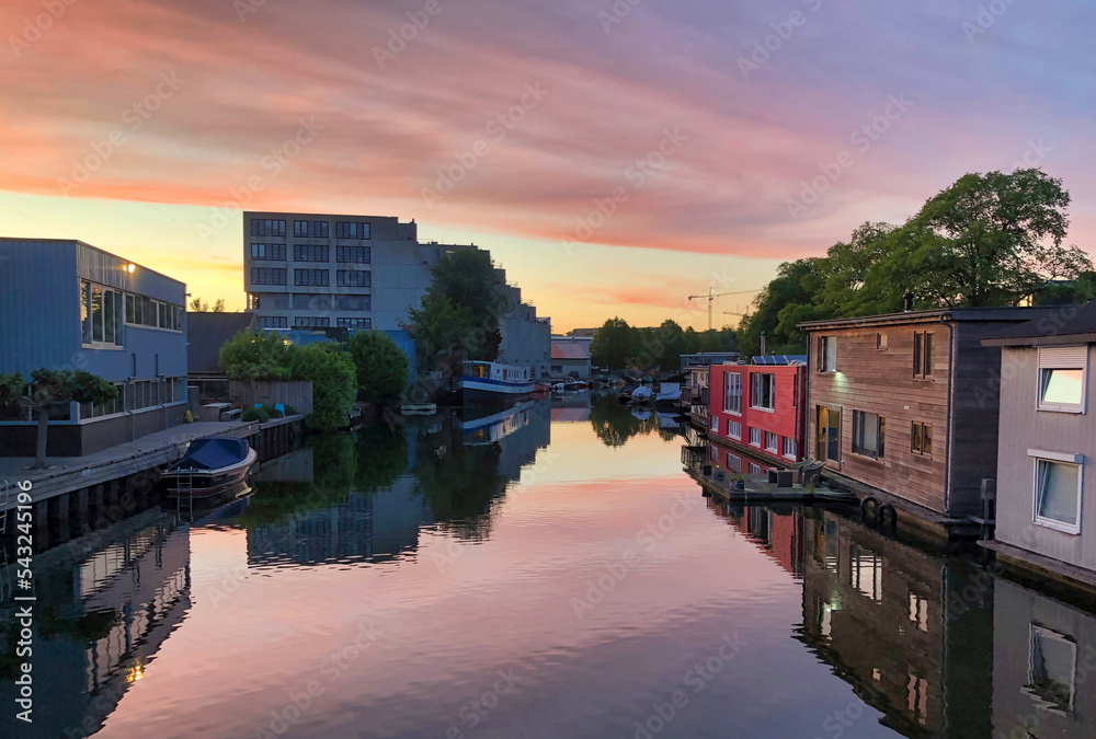 sunset over the amsterdam canals in summer