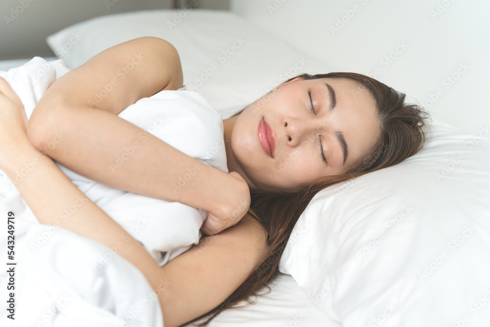 beautiful woman sleeping well on white soft pillow on the bed at home.