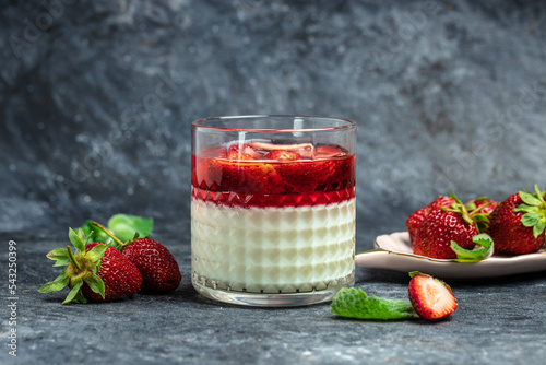 panna cotta dessert with strawberry and mint on a dark background, Long banner format. top view