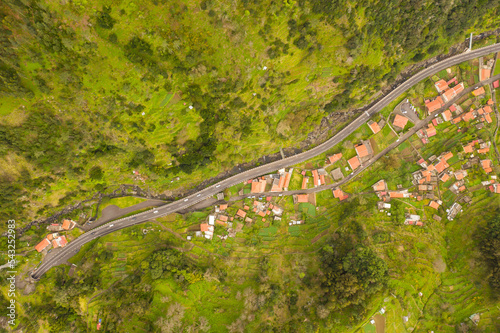 Drone photography or road going to mountain tunnel and a little town near it