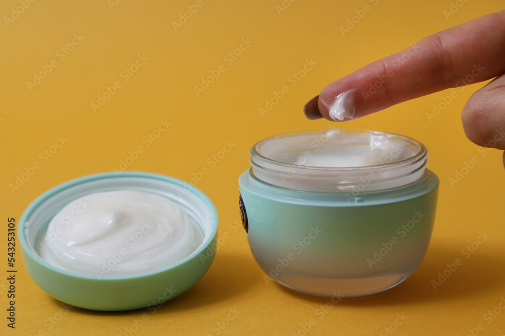 container with cream arrangement on orange background container with cream arrangement on orange background