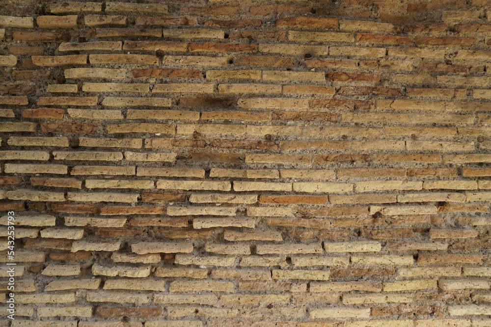 Detail of a wall in Roman structure made of bricks and with the opus