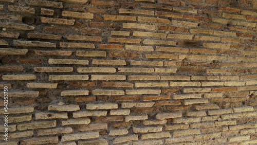 Fotografija Detail of a wall in Roman structure made of bricks and with the opus reticulatum technique in blocks of porphyry, in the archaeological site of Ostia Antica