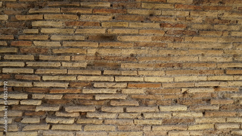 Bild auf Leinwand Detail of a wall in Roman structure made of bricks and with the opus reticulatum technique in blocks of porphyry, in the archaeological site of Ostia Antica