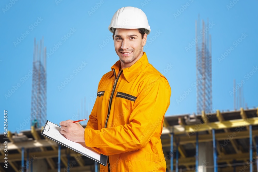 Professional young man with a tablet posing on construction site. Professional young man with a tablet posing on construction site.