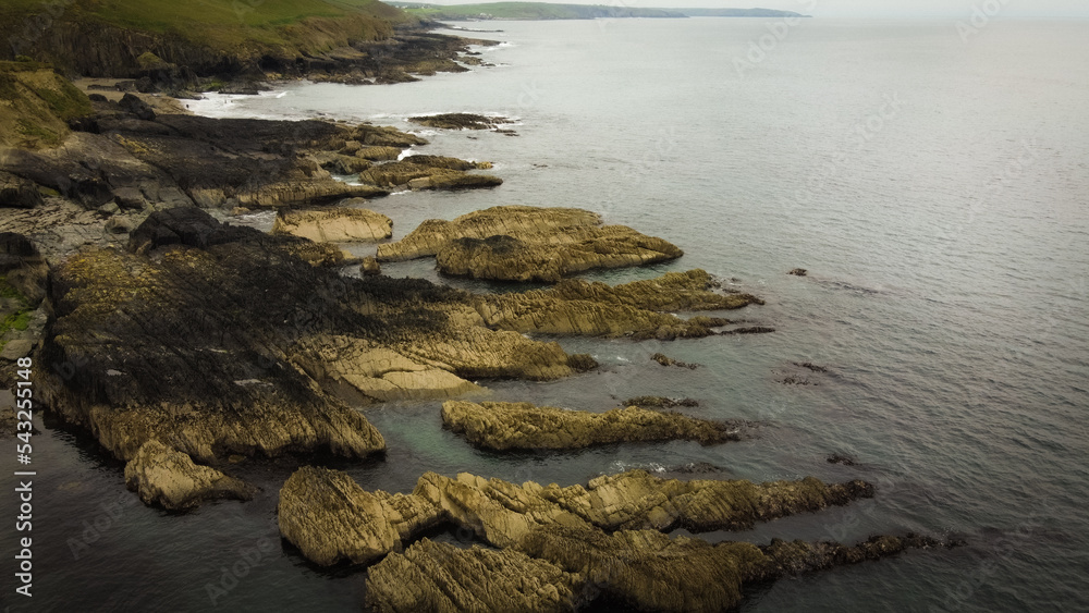 Rocks in seawater, top view. Geological formations on the Atlantic Ocean coast. Drone point of view.