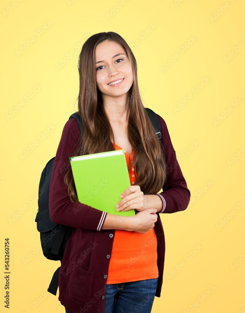 Young student with gadget posing on a background. Young student with gadget posing on a background.