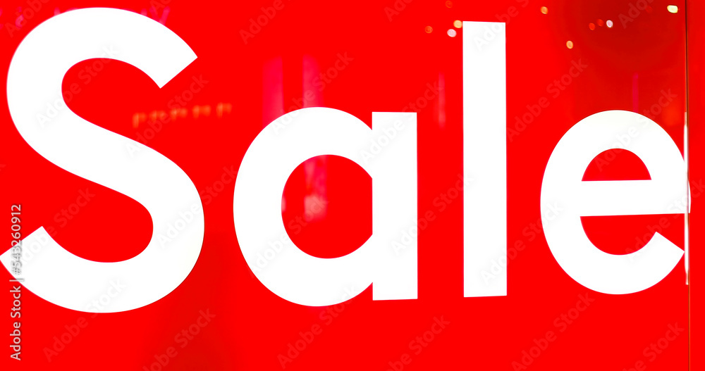 Big sign on red background with white SALE words at entrance Big sign on red background with white SALE words at entrance