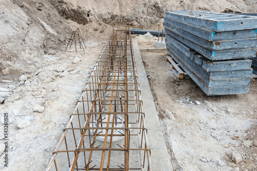 Monolithic foundation with metal reinforcement. Reinforcement construction mesh. Concrete pile foundation after completed for new construction site. The construction tool for monolithic works.