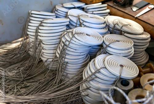 Ceramic insulators with nichrome wire spirals close-up in the mechanical assembly shop of the enterprise