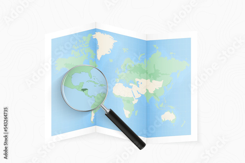 Enlarge Honduras with a magnifying glass on a folded map of the world.