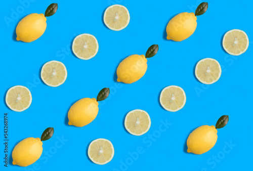 Fototapeta Naklejka Na Ścianę i Meble -  Lemon on the blue background. Flat lay. Pattern. Top view.