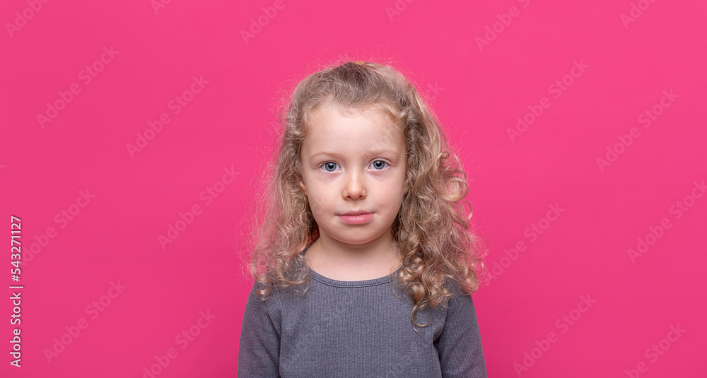 Little nice-looking lovely sweet curious cheerful girl on the pink color background. Little nice-looking lovely sweet curious cheerful girl on the pink color background.