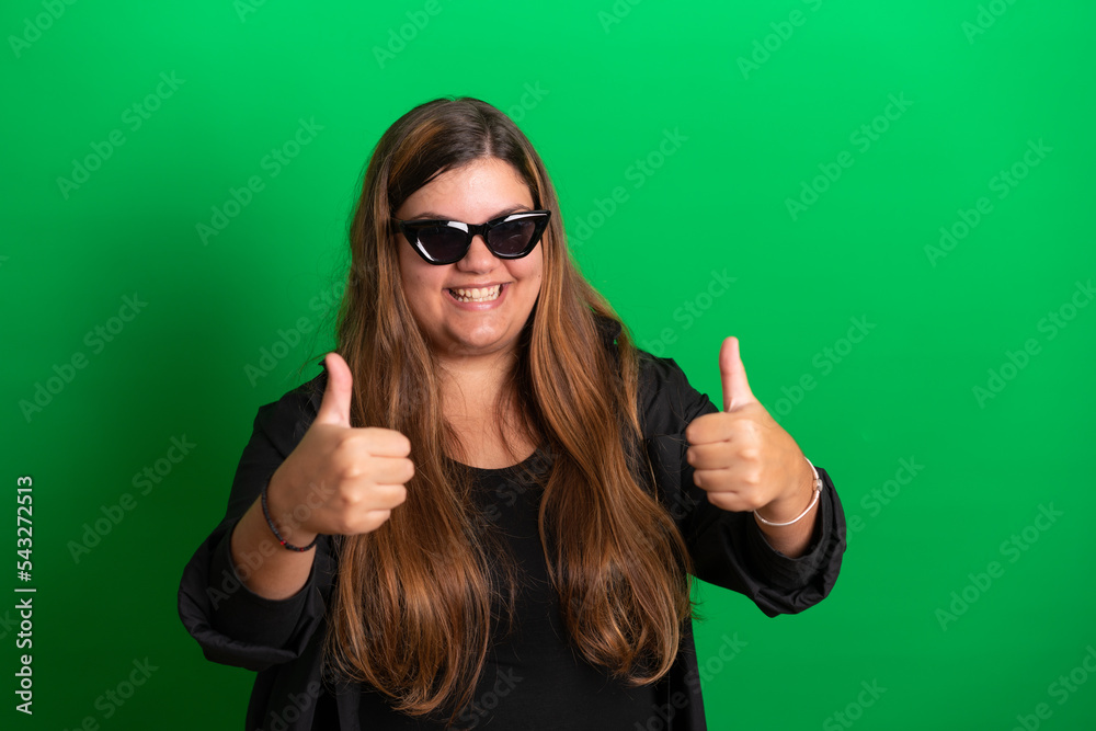 Young woman, wearing black glasses on Green Background Young woman, wearing black glasses on Green Background