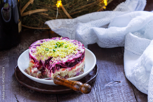 Obraz na płótnie Dressed herring, raditional Soviet festive salad of herring and vegetables in a New Year's decoration. w salonie