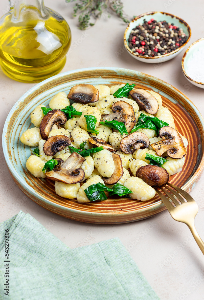 Gnocchi in a creamy sauce with mushrooms and spinach. Healthy eating. Vegetarian food. Gnocchi in a creamy sauce with mushrooms and spinach. Healthy eating. Vegetarian food.