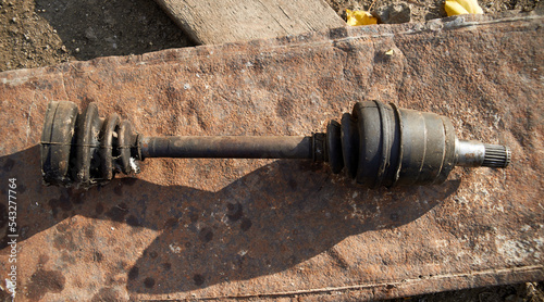 Photo of old used front drive axle photo