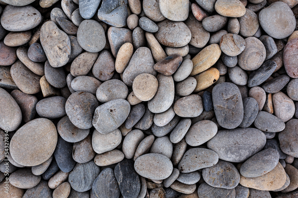 Many multi-colored stones of different oval and round shapes on the ocean, texture background of stones.
Many multi-colored stones of different oval and round shapes on the ocean, texture background of stones.