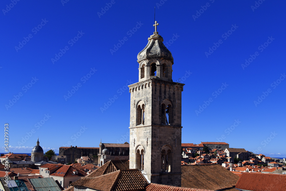 slim tower above the Dominican Monastery with classic red tiled rooftops inside the old town of Dubrovnik, Croatia