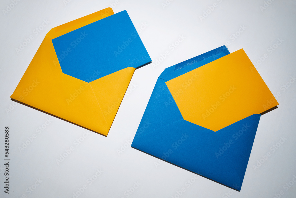 Yellow and blue envelopes on a white background. A set of envelopes in different types. Paper envelopes for inscriptions. Top view mockup
Yellow and blue envelopes on a white background. A set of envelopes in different types. Paper envelopes for inscriptions. Top view mockup