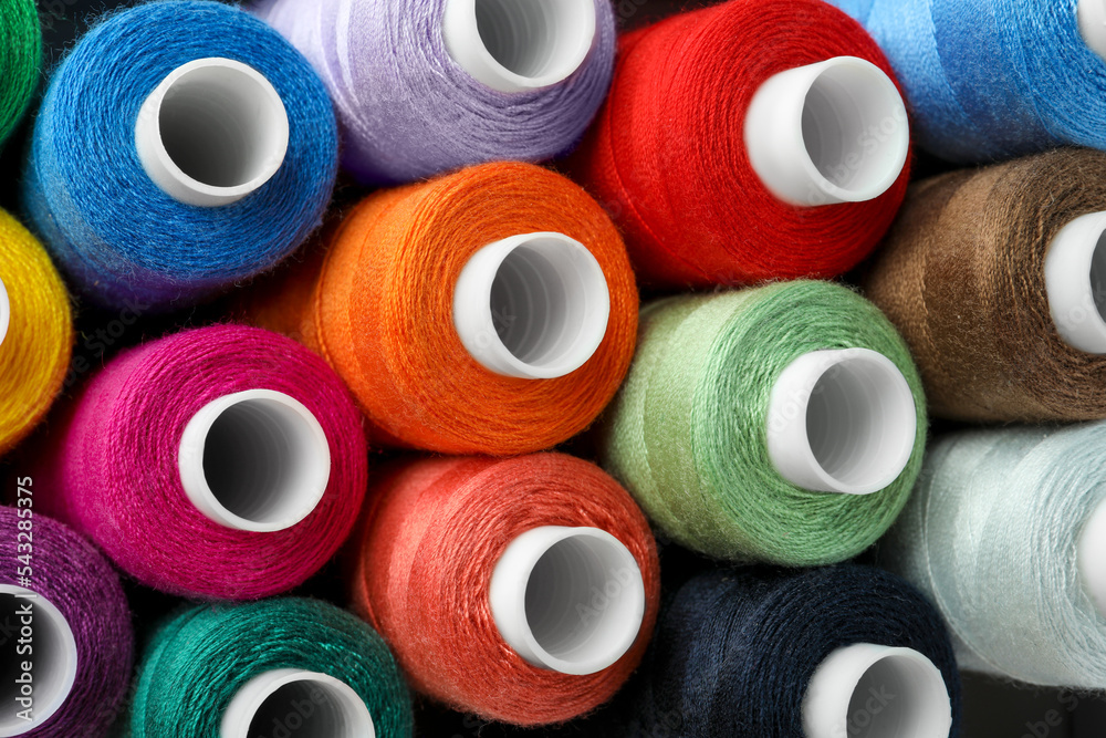 Top view of colorful sewing threads as background, closeup Top view of colorful sewing threads as background, closeup