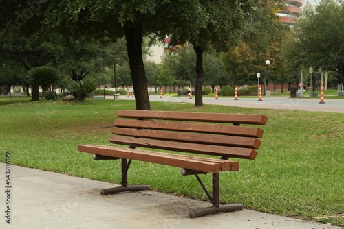 Stylish wooden bench in park on sunny day