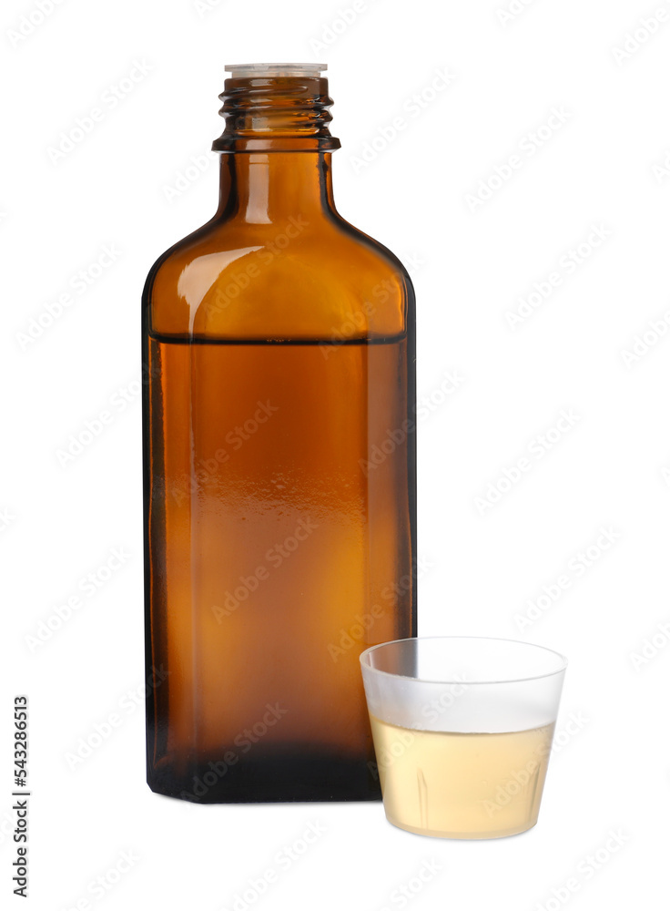 Bottle with measuring cup of syrup on white background. Cough and cold medicine Bottle with measuring cup of syrup on white background. Cough and cold medicine