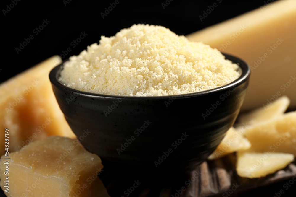 Bowl with grated parmesan cheese on table, closeup Bowl with grated parmesan cheese on table, closeup