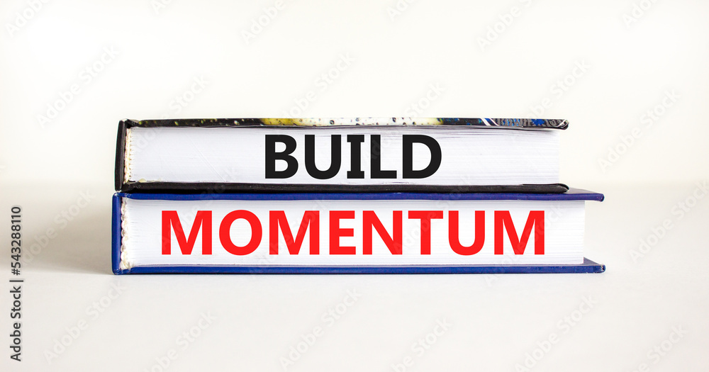Build momentum symbol. Concept words Build momentum on books. Beautiful white table white background. Business and build momentum concept. Copy space.