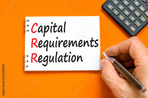 CRR capital requirements regulation symbol. Concept words CRR capital requirements regulation on white note on a orange background. Business CRR capital requirements regulation concept. Copy space. photo