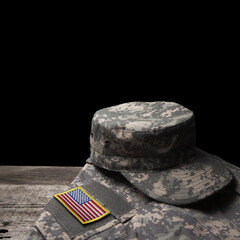 USA military uniform with insignias on old wooden table on black background. Memorial Day or Veterans day concept.