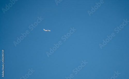 Antonov An-124 Ruslan, a very large 4 engine strategic airlift airplane in low level flight, clear blue sky, Wiltshire UK photo