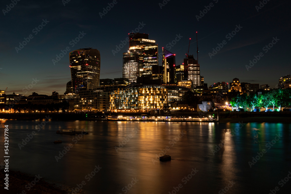 London city at night with reflections in the water