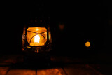 Kerosene lamp at the garden table during the night.