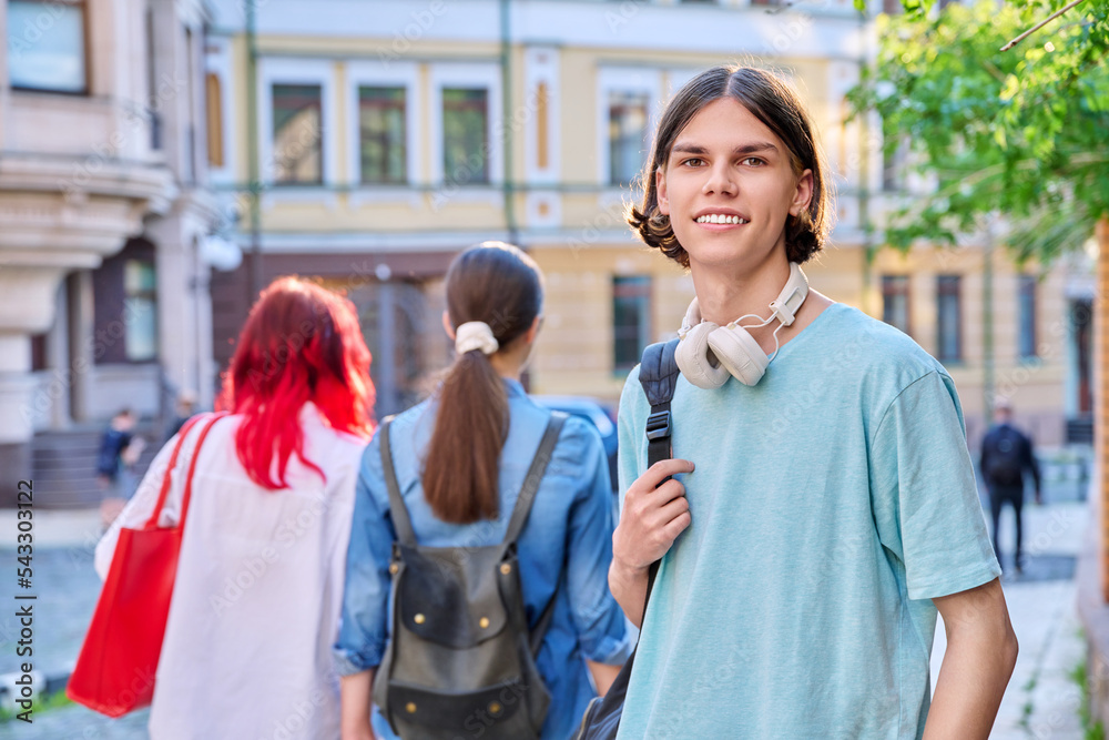 Obraz premium Portrait of teenage guy looking at camera outdoor