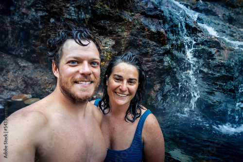 Man and woman take a selfie at the thermal healing waters geothermal hot springs in nature in the back country of Idaho USA.